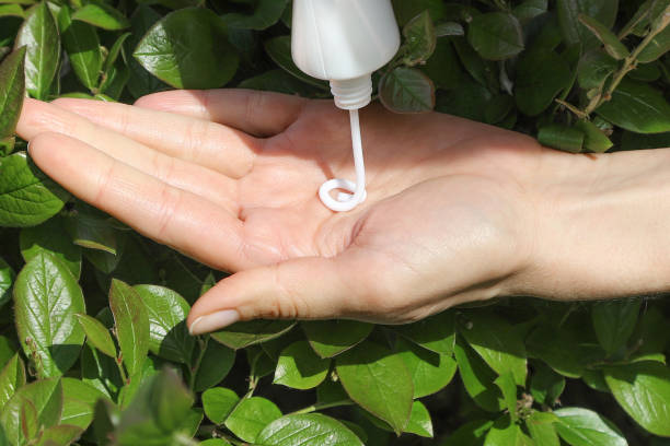 Hand applying non-greasy Picaridin insect repellent on skin
